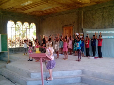 Neighborhood kids singing in the Banuar SDA church.